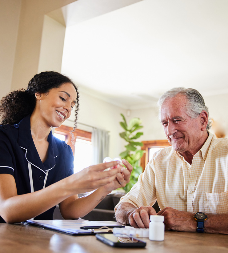 Female-caregiver-explaining-medication-to-male-senior