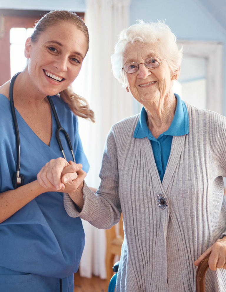 Nursing-holding-elderly-woman’s-hand-after-providing-incontinence-care